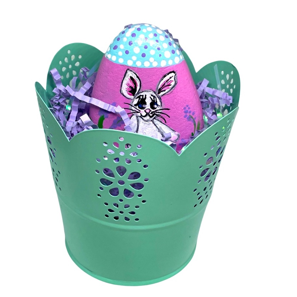 Hand crafted painted rabbit rock stone in green metal basket white Easter bunny